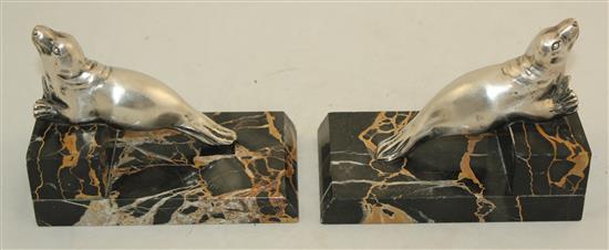 A pair of French Art Deco silvered bronze and marble seal bookends, 6in.